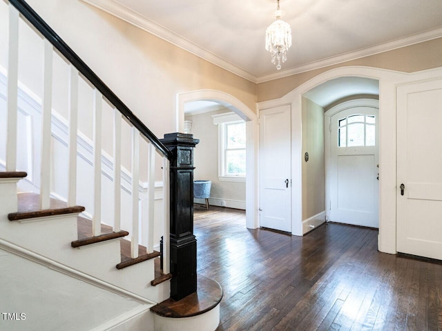 2501 Kenmore Dr, Raleigh, NC 27608 - entryway featuring arched walkways, dark wood-style floors, stairs, and ornamental molding