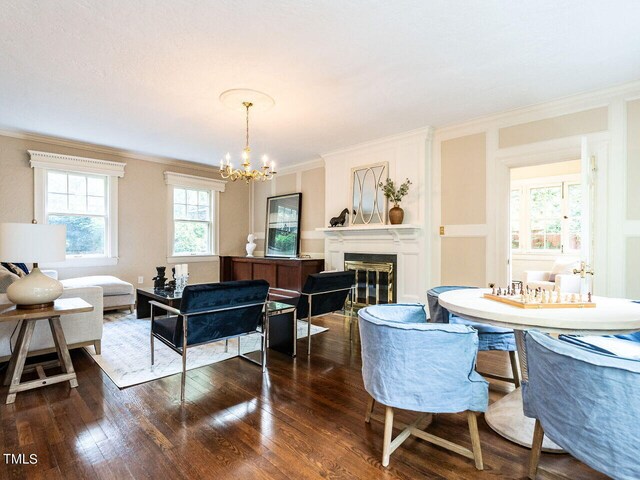 dining area featuring crown molding, dark wood-type flooring, and a chandelier