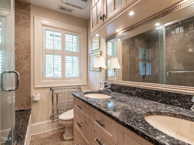 bathroom with vanity, toilet, and an enclosed shower