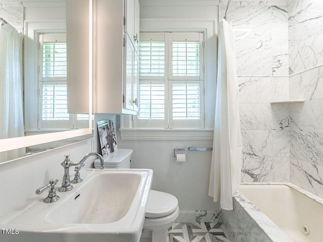 full bathroom featuring shower / bath combination with curtain, sink, and toilet