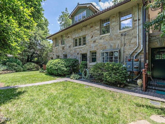 2501 Kenmore Dr, Raleigh, NC 27608 - rear view of property featuring stone siding and a lawn