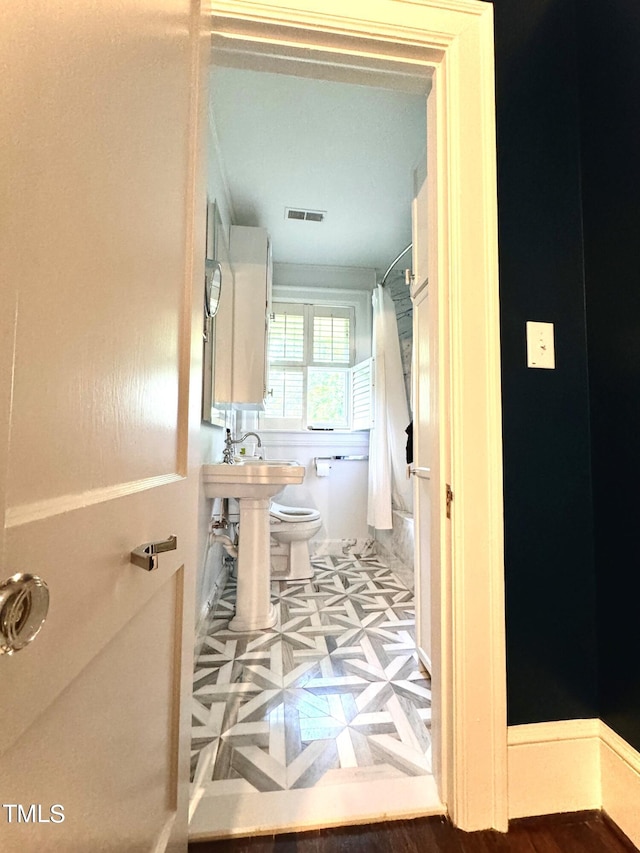 2501 Kenmore Dr, Raleigh, NC 27608 - bathroom with visible vents and toilet