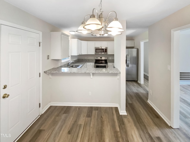 kitchen featuring light stone countertops, stainless steel appliances, dark hardwood / wood-style flooring, white cabinetry, and sink