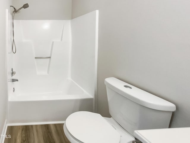 full bathroom featuring wood-type flooring, toilet, vanity, and shower / washtub combination