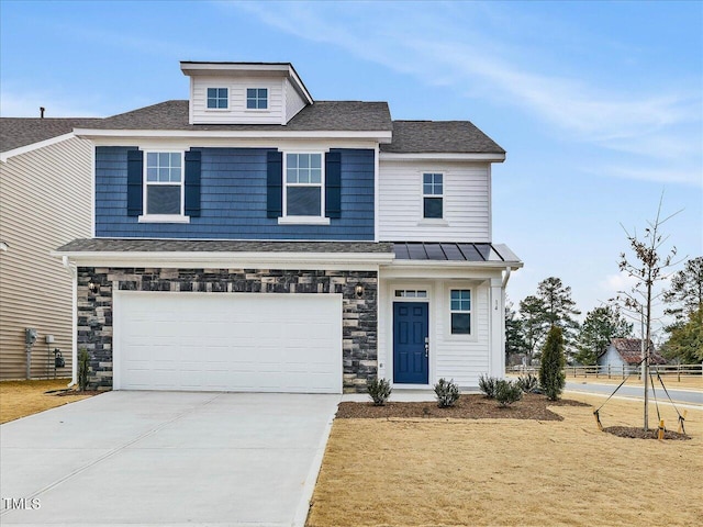 view of front facade featuring driveway, a garage, stone siding, metal roof, and a standing seam roof