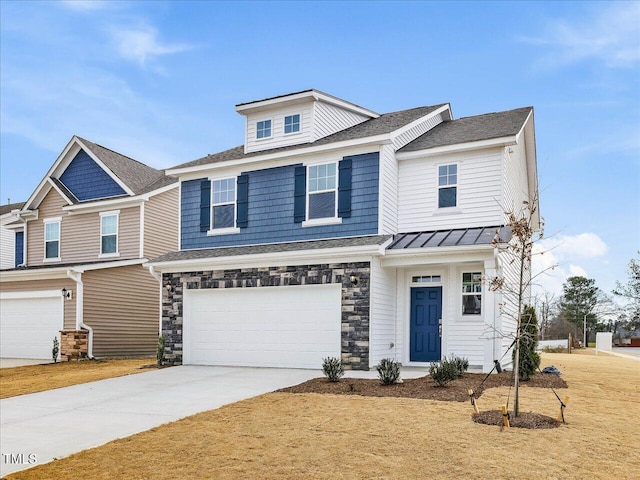 view of front of house with a standing seam roof, an attached garage, stone siding, and driveway