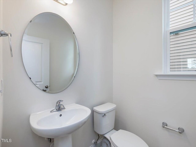 half bath with a sink and toilet