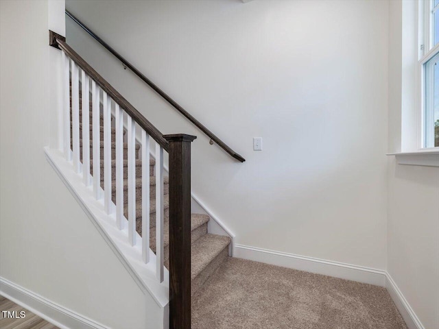 staircase with carpet flooring and baseboards