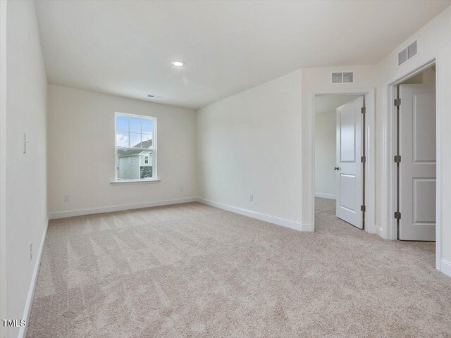 carpeted empty room with visible vents, recessed lighting, and baseboards