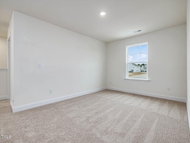 empty room featuring recessed lighting, visible vents, carpet floors, and baseboards