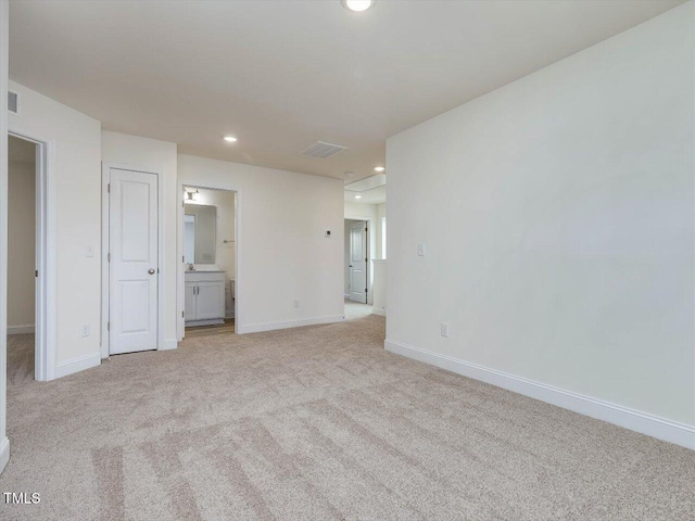 unfurnished room with visible vents, recessed lighting, light colored carpet, and baseboards