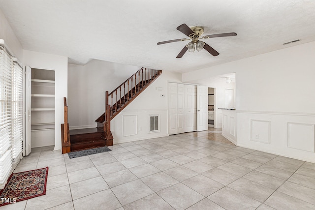 unfurnished living room featuring ceiling fan