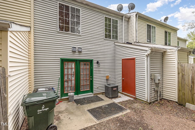 rear view of house featuring central air condition unit