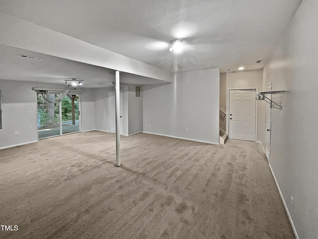 unfurnished living room with visible vents, carpet, and baseboards