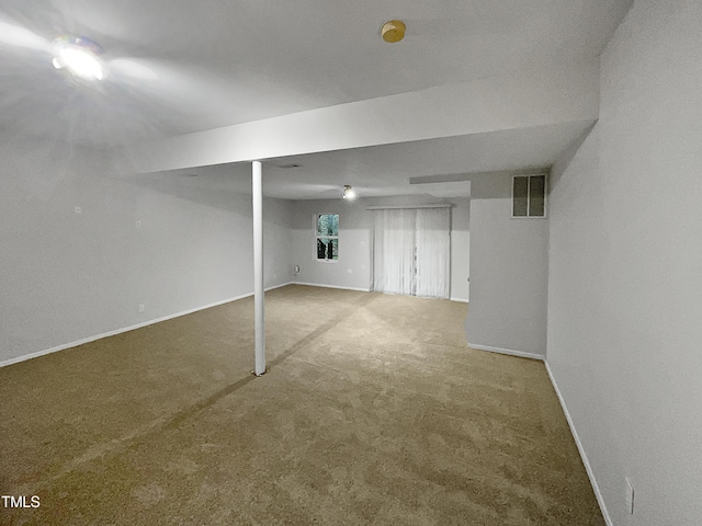 finished below grade area with visible vents, baseboards, and carpet floors