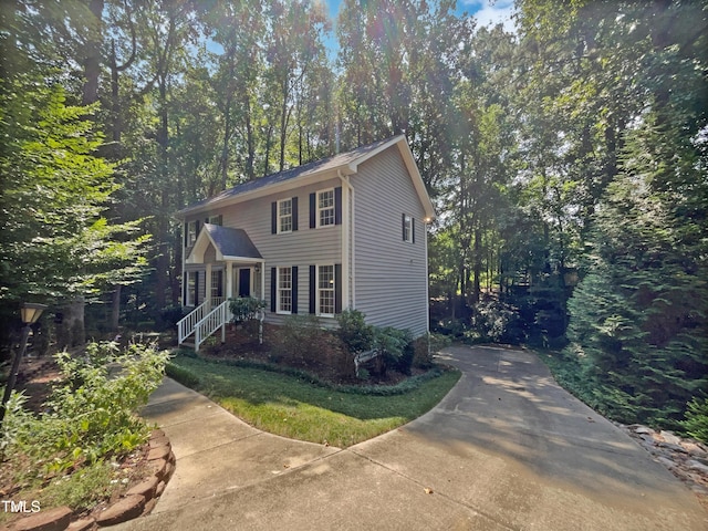 colonial-style house featuring a view of trees