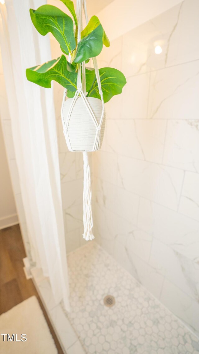 interior details featuring a shower with shower curtain