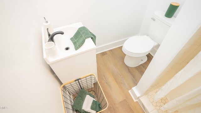 bathroom featuring hardwood / wood-style floors and toilet