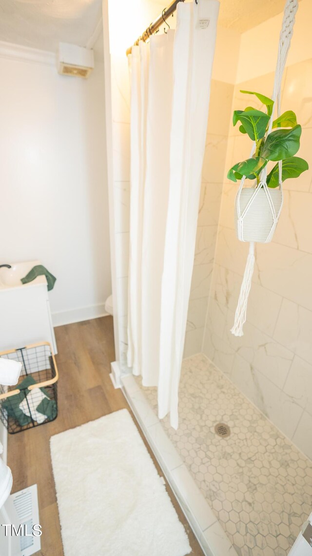 bathroom featuring hardwood / wood-style flooring and a shower with shower curtain