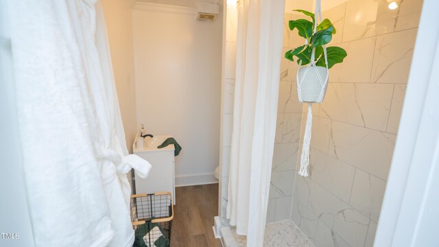 bathroom featuring wood-type flooring, toilet, and a shower with shower curtain