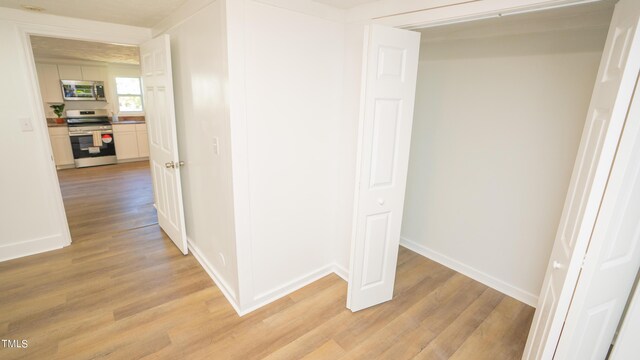 hall with light wood-type flooring