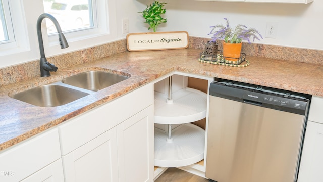 kitchen with white cabinets, dishwasher, and sink