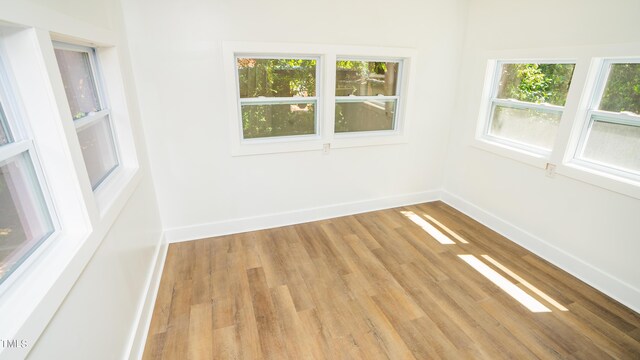 unfurnished room with wood-type flooring