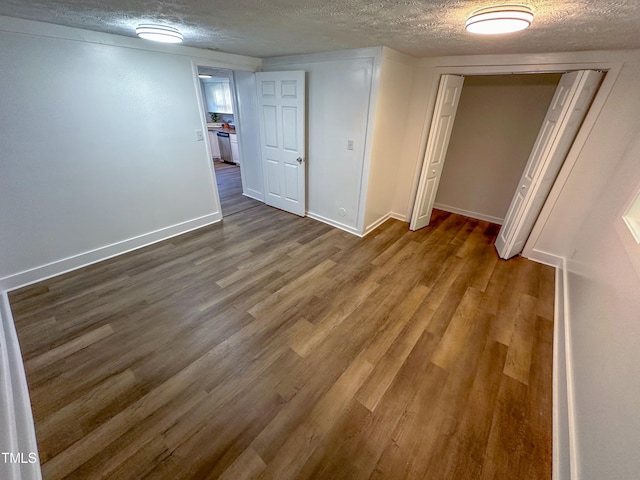 interior space featuring a textured ceiling and hardwood / wood-style flooring