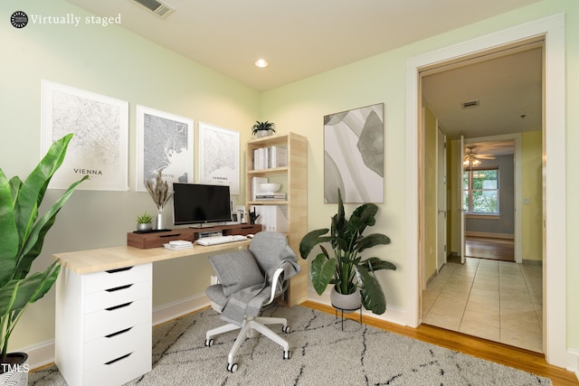 home office featuring ceiling fan and light hardwood / wood-style floors