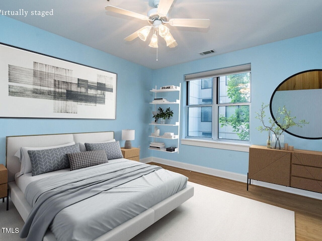 bedroom featuring ceiling fan and hardwood / wood-style flooring