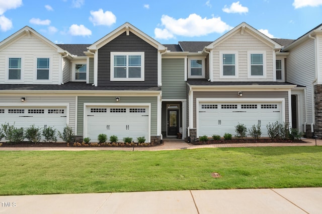 view of front of property featuring a garage and a front lawn