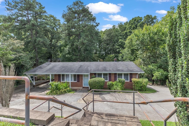 single story home featuring brick siding