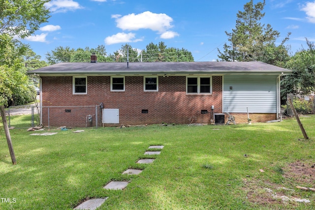 rear view of property with brick siding, fence, central AC, a yard, and crawl space