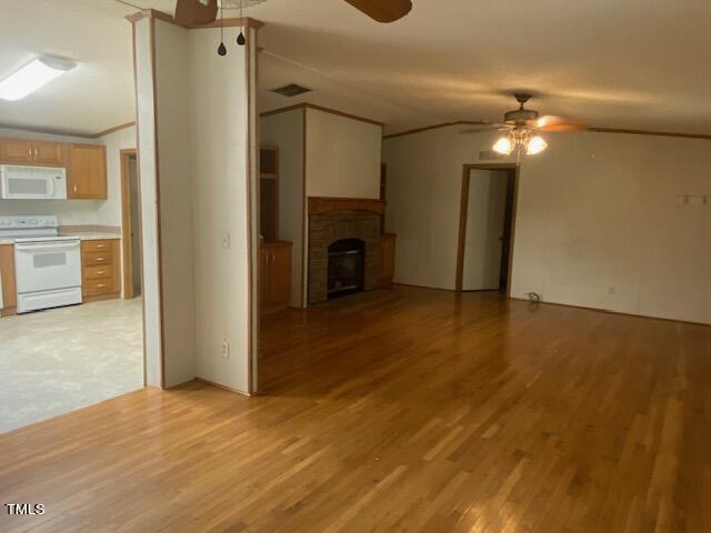 unfurnished living room with light hardwood / wood-style flooring and ceiling fan