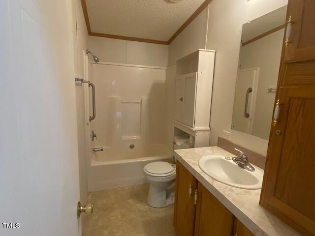 full bathroom with a textured ceiling, vanity, toilet, shower / bathtub combination, and ornamental molding