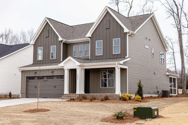 craftsman-style home with board and batten siding, an attached garage, roof with shingles, and concrete driveway