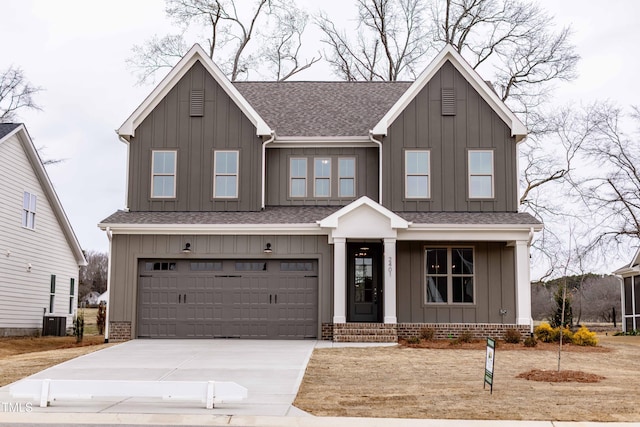 view of front of home featuring roof with shingles, board and batten siding, concrete driveway, a garage, and central AC unit