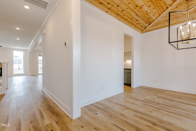 interior space featuring visible vents, baseboards, wood ceiling, a fireplace, and light wood-style floors