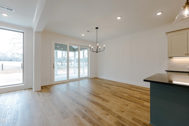 unfurnished dining area with a notable chandelier, visible vents, light wood-style flooring, and recessed lighting