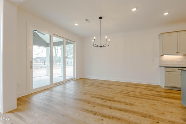 unfurnished dining area with visible vents, baseboards, recessed lighting, light wood-type flooring, and a chandelier