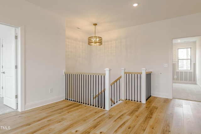 empty room featuring recessed lighting, wood finished floors, and baseboards