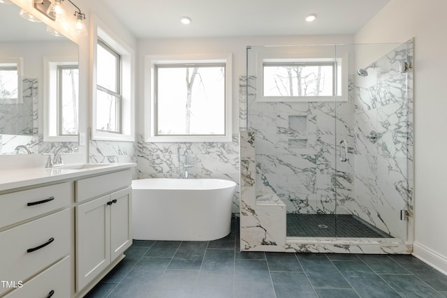 full bath with a marble finish shower, tile walls, recessed lighting, a soaking tub, and vanity