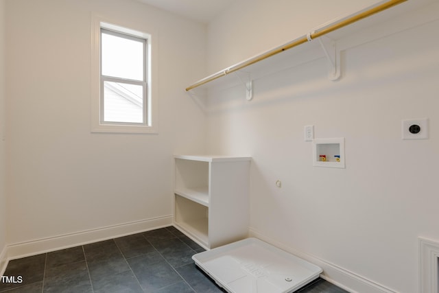 clothes washing area featuring baseboards, dark tile patterned floors, laundry area, hookup for a washing machine, and electric dryer hookup