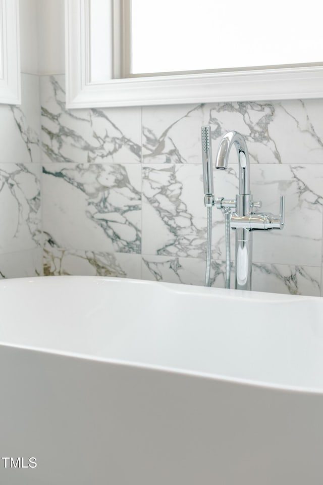 interior details with a sink and a freestanding tub