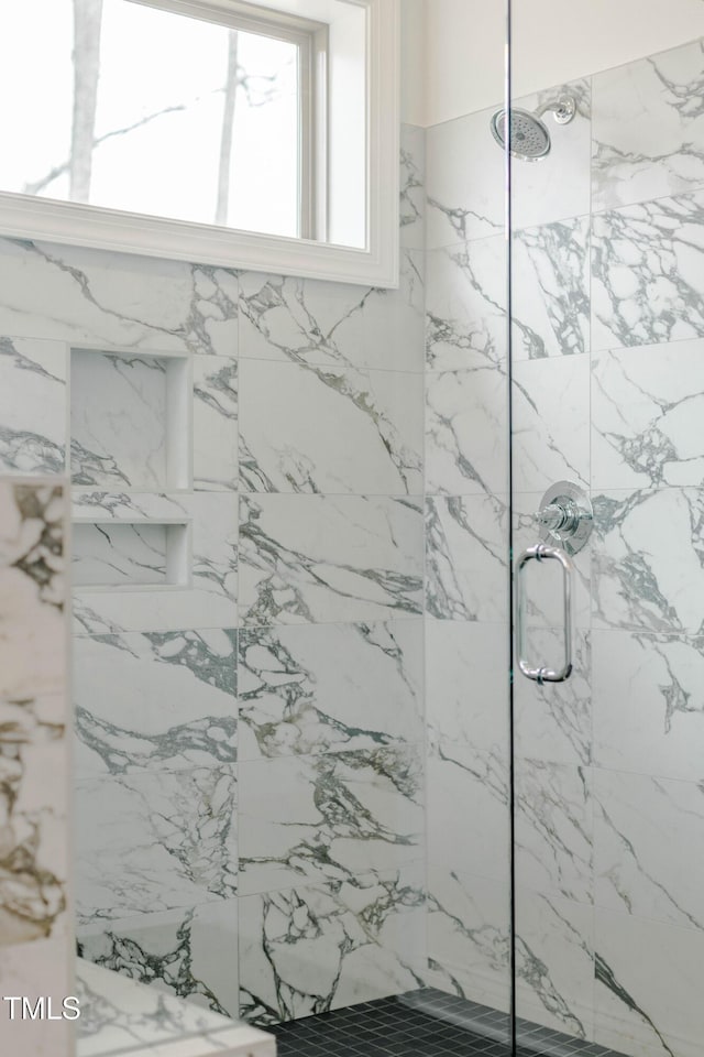 bathroom with a marble finish shower