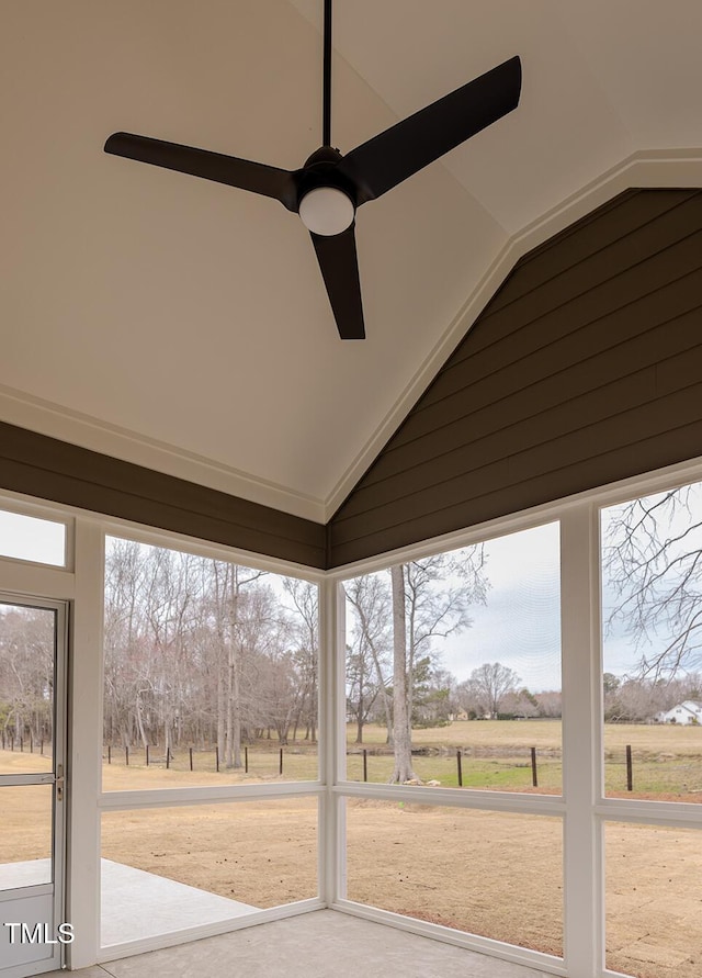 interior space featuring plenty of natural light, ceiling fan, and vaulted ceiling