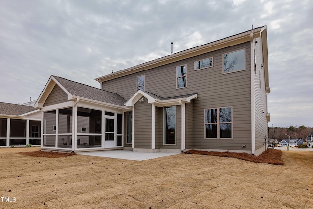 rear view of property featuring a patio area and a sunroom