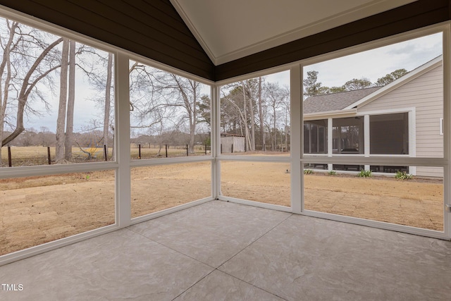 unfurnished sunroom with lofted ceiling