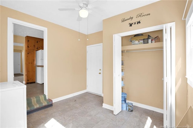 unfurnished bedroom featuring a closet, white fridge, independent washer and dryer, and ceiling fan