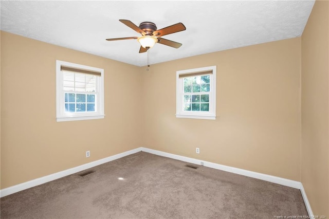 carpeted empty room with a textured ceiling and ceiling fan